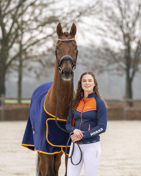 dressuuramazone robin heiden poseert naast haar paard hollywood